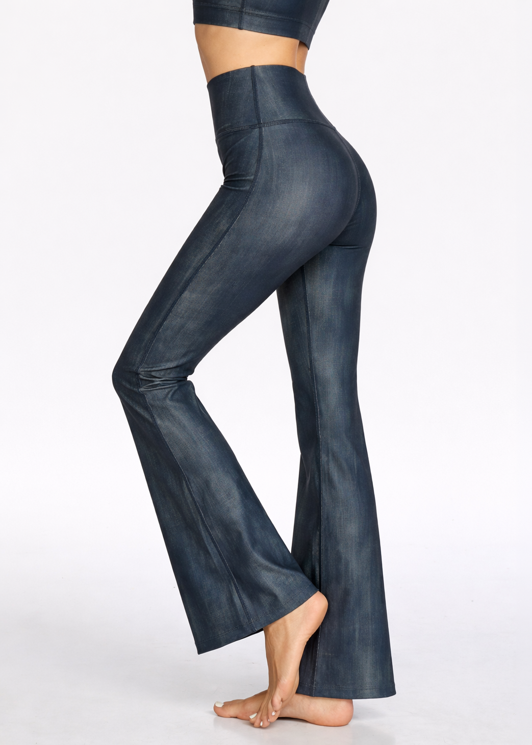 Dark blue flared pants worn by a person on a white background